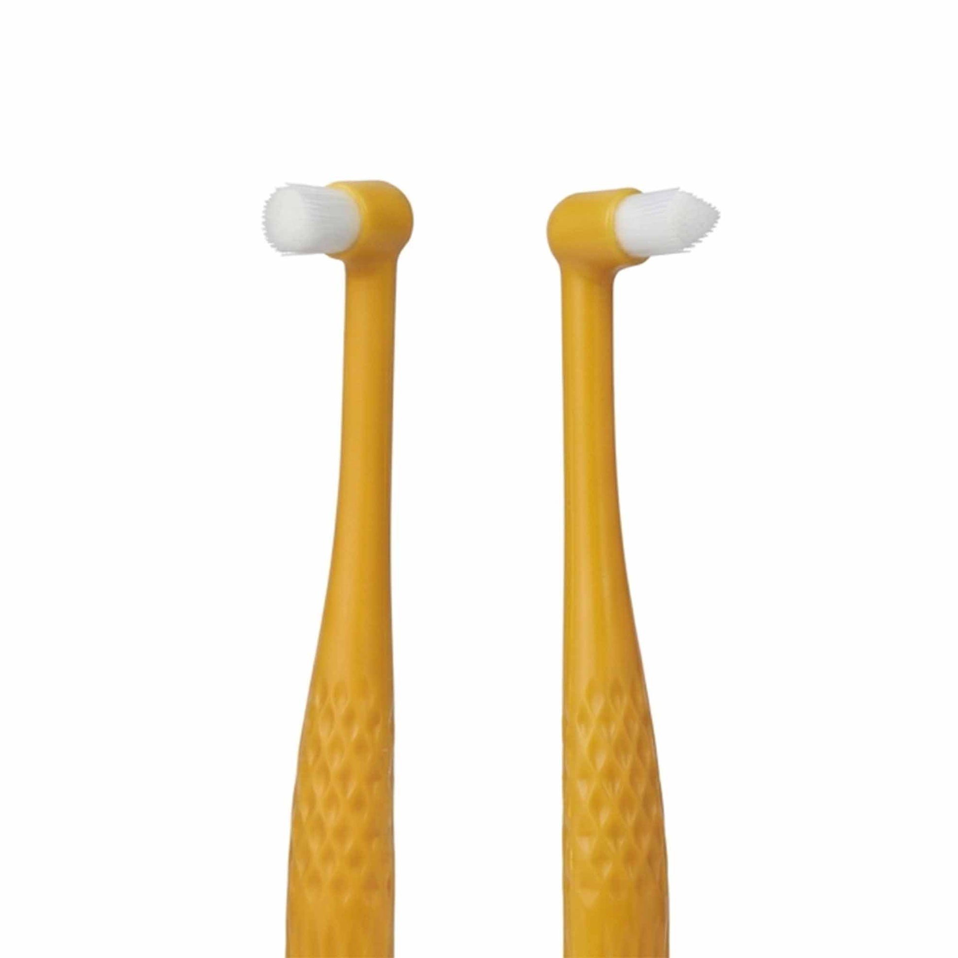 Close-up of dual-head pet toothbrush – tapered tip reaches back molars, rounded tip cleans front teeth and gums with soft silicone bristles