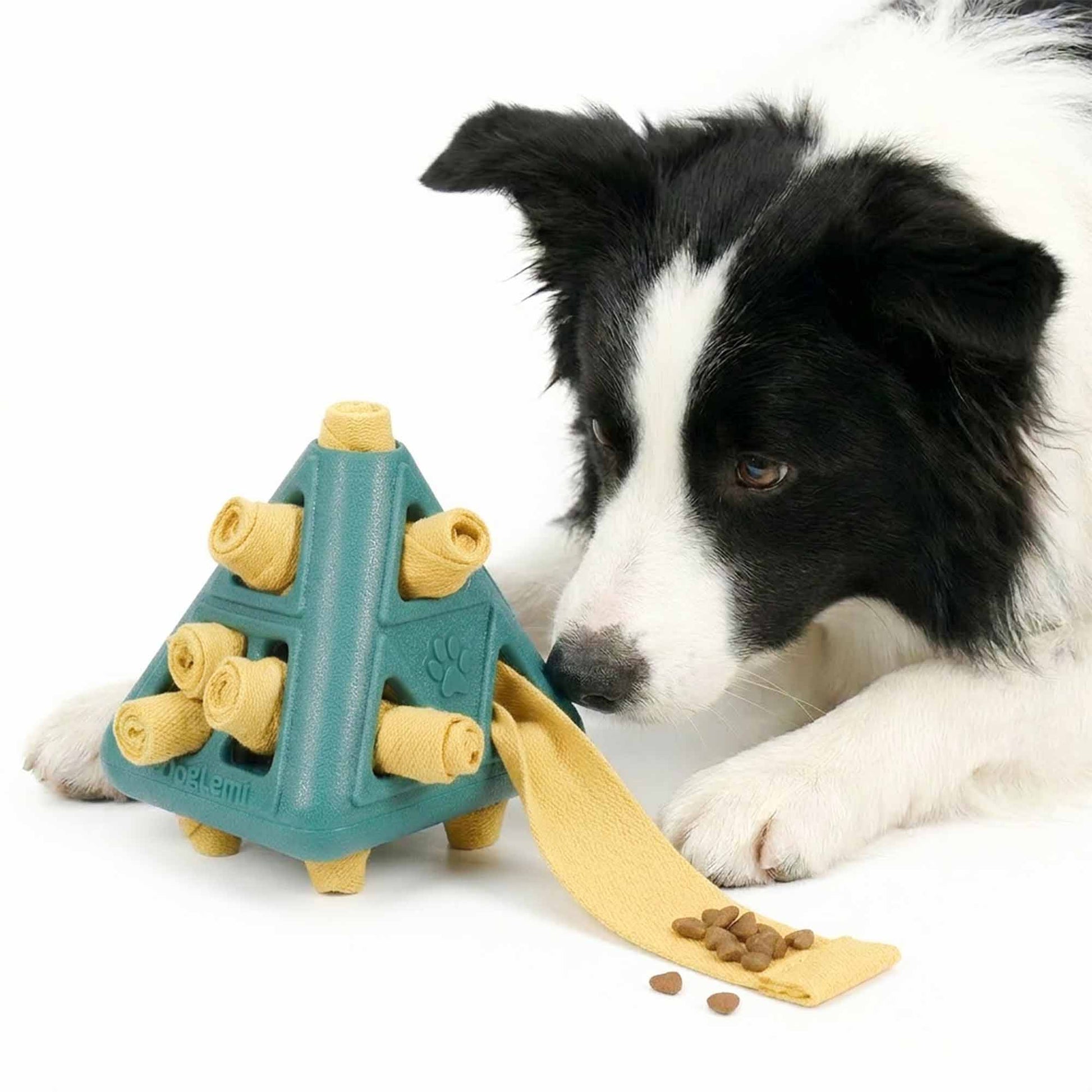 Dog chewing textured TPR pyramid treat dispenser toy with fabric rolls – gentle plaque removal and gum massage during rewarding play