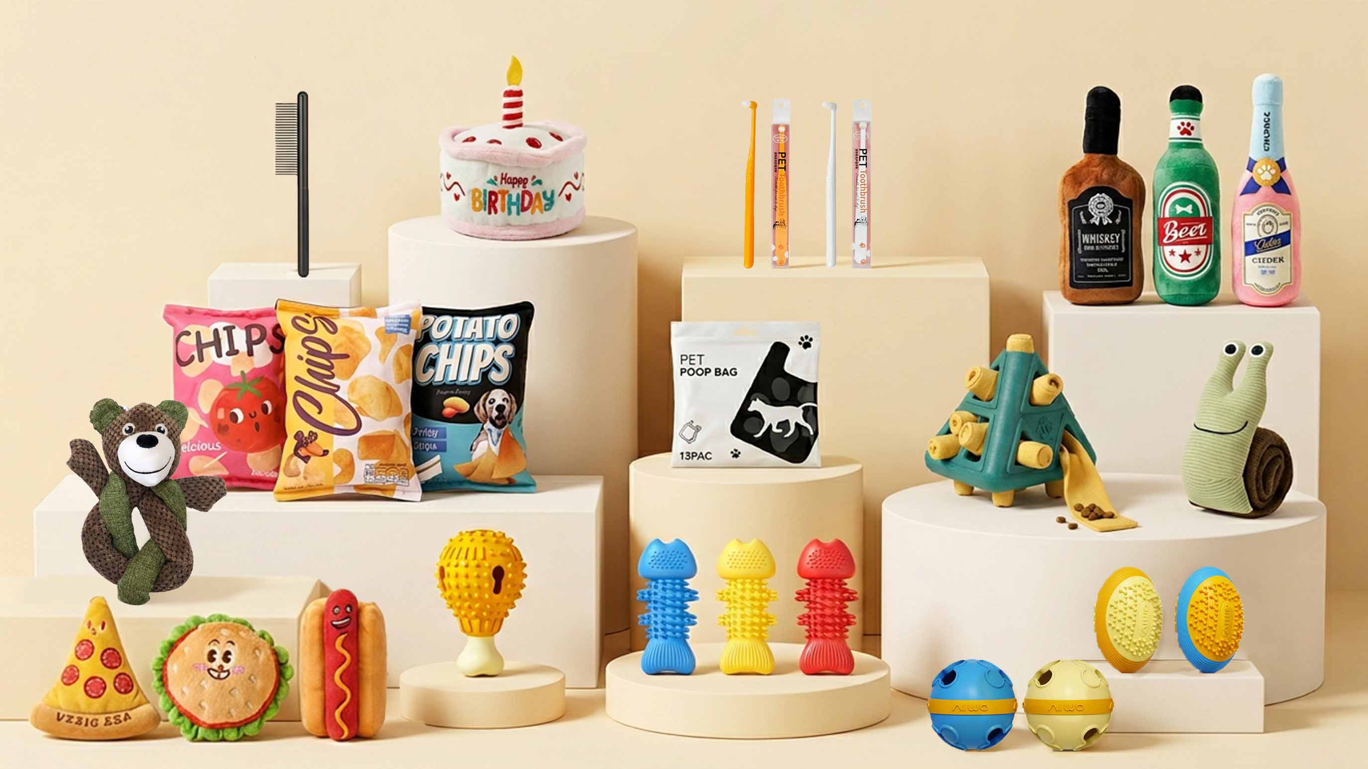 Hound Group dog toys bundle studio display featuring food-shaped plush toys, birthday cake toy, pet poop bags, toothbrush set, and interactive chew toys on white blocks