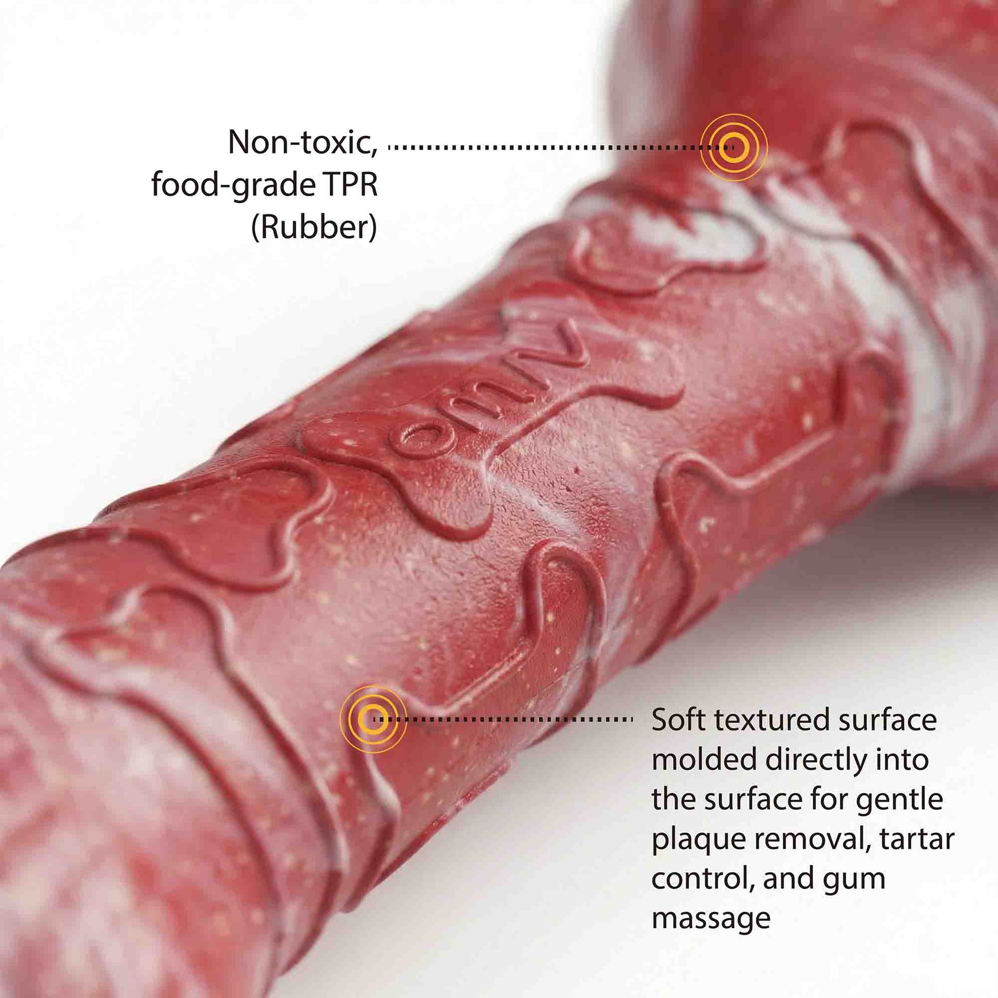 Close-up of red marble TPR dog bone chew toy showing non-toxic food-grade rubber material and soft textured surface for plaque removal and gum massage