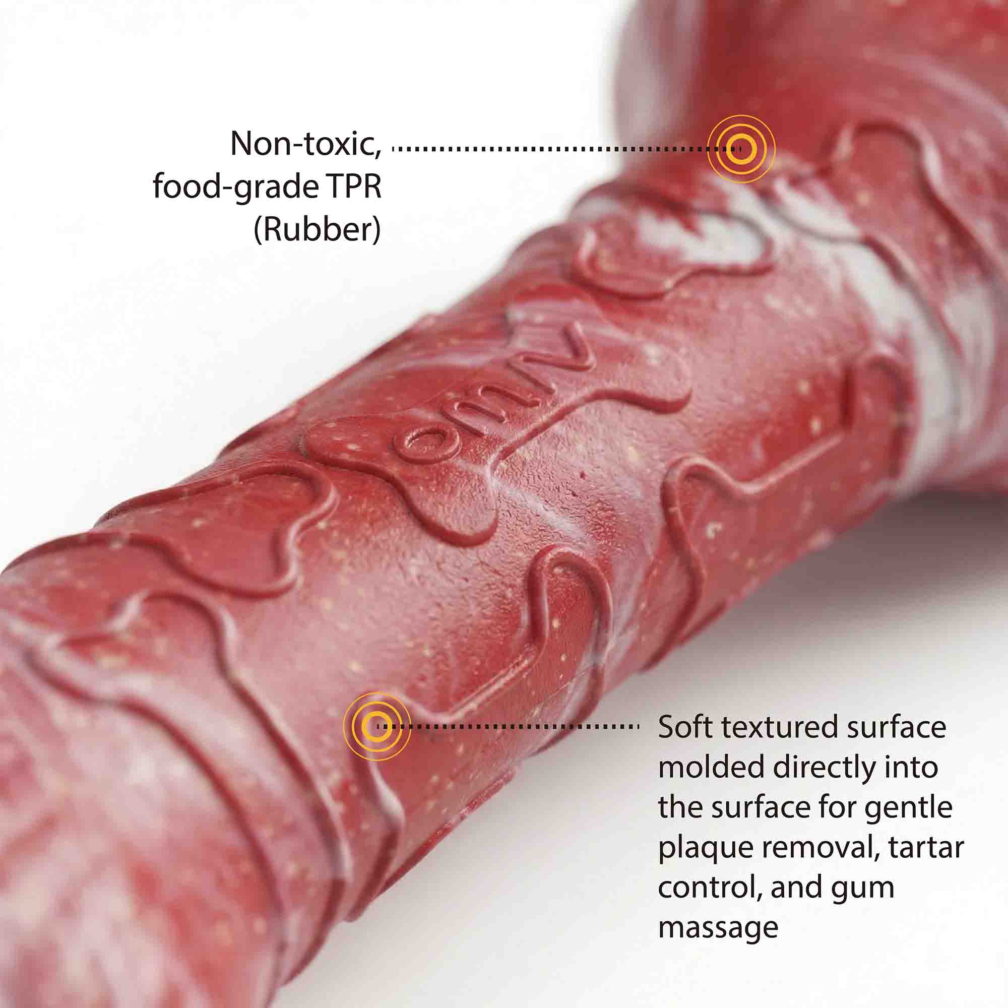 Close-up of red marble TPR dog bone chew toy showing non-toxic food-grade rubber material and soft textured surface for plaque removal and gum massage