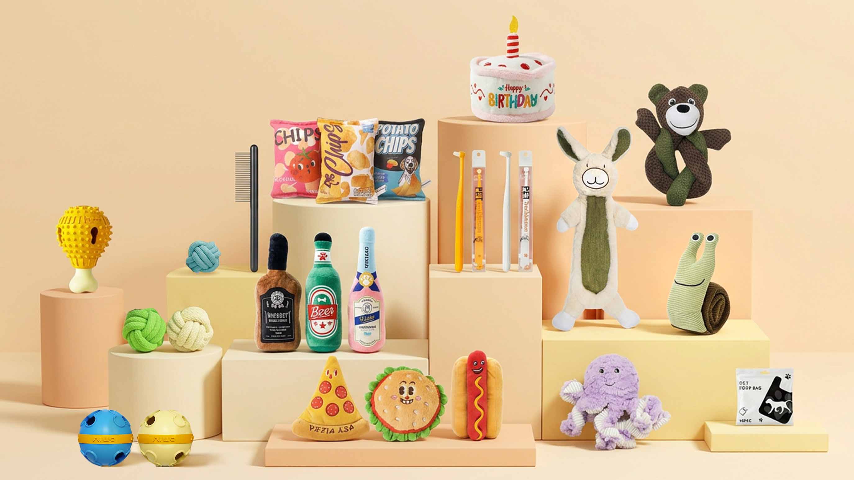 Toy Group dog toys bundle studio display featuring food plush toys, birthday cake toy, bottle plush, rabbit, bear, octopus, puzzle toys and more on white blocks